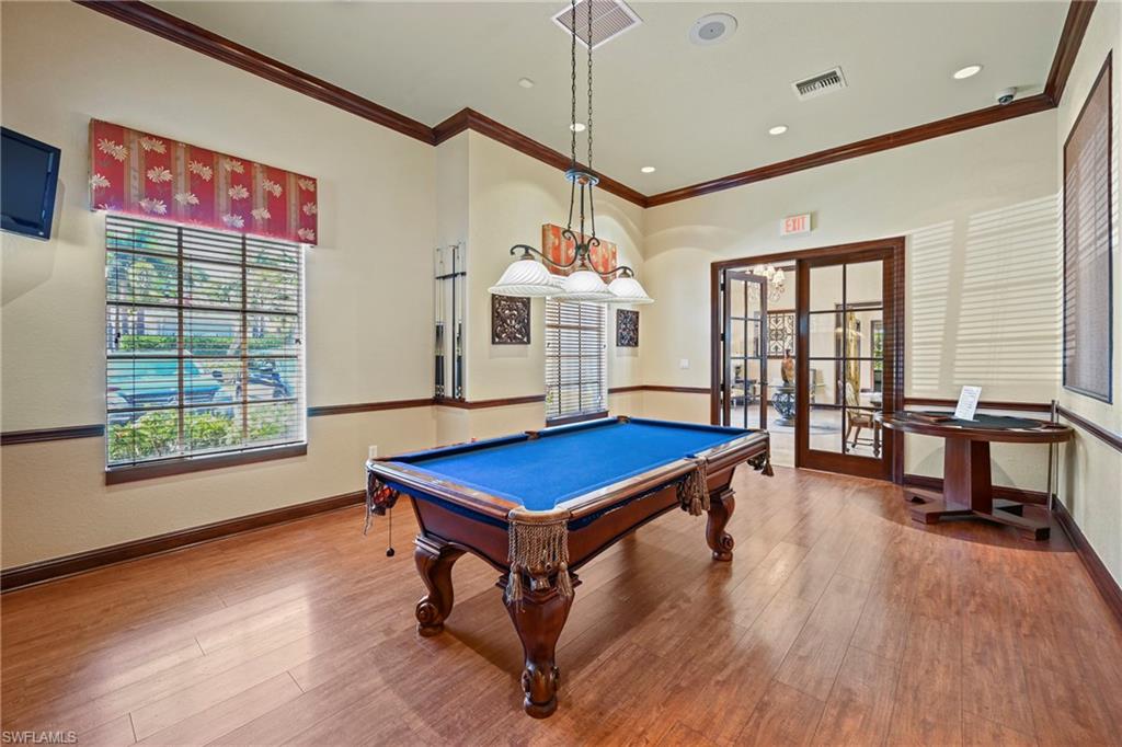 Recreation room featuring wood-finish flooring, a pool table with blue felt, and dual French doors