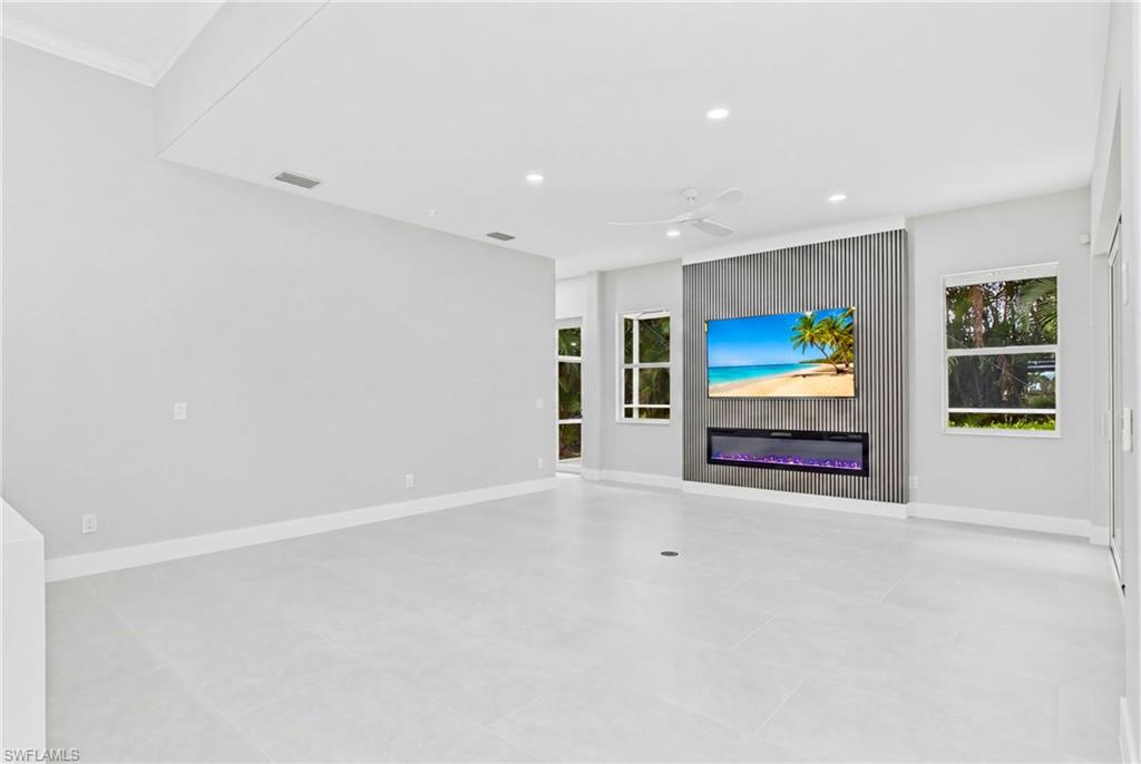 Living room with feature wall with Tv and fireplace