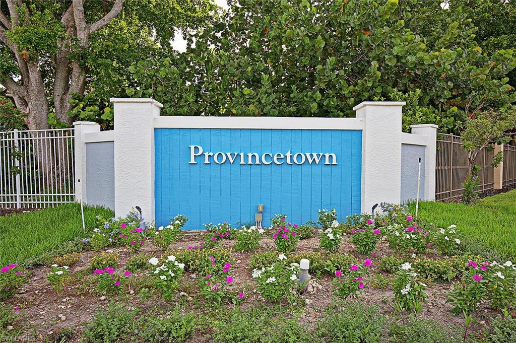 Community entry monument with white stucco pillars, a bright blue textured panel, and white dimensional lettering