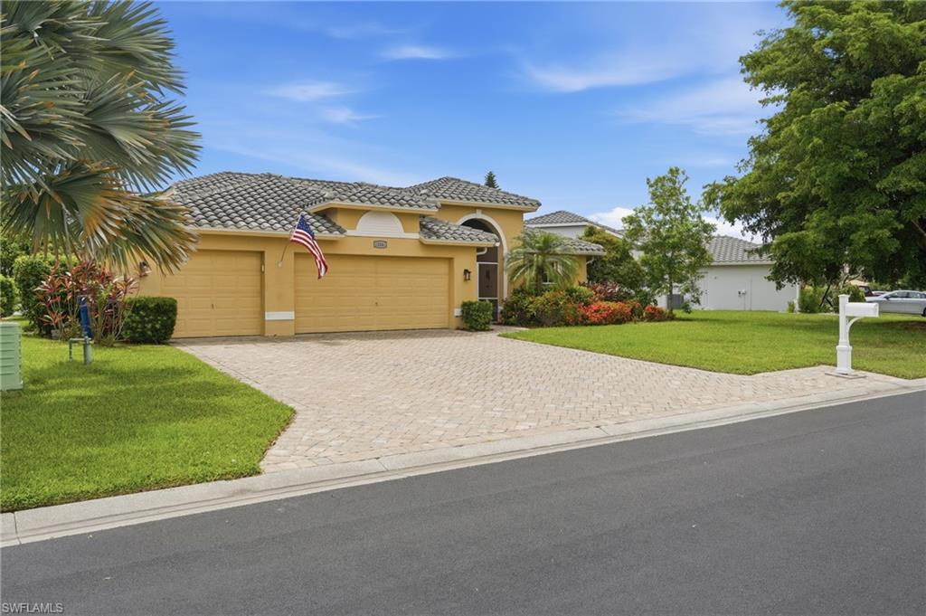 Exterior featuring a tiled roof, stucco finish, and an arched entryway