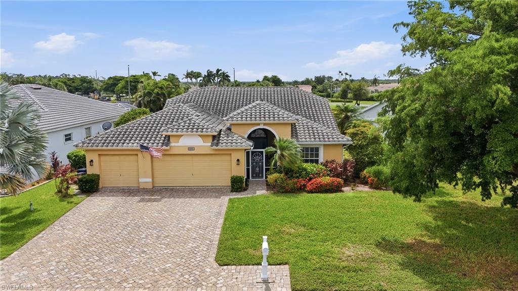 Tile roof with varied pitch, two-car garage, and arched entry