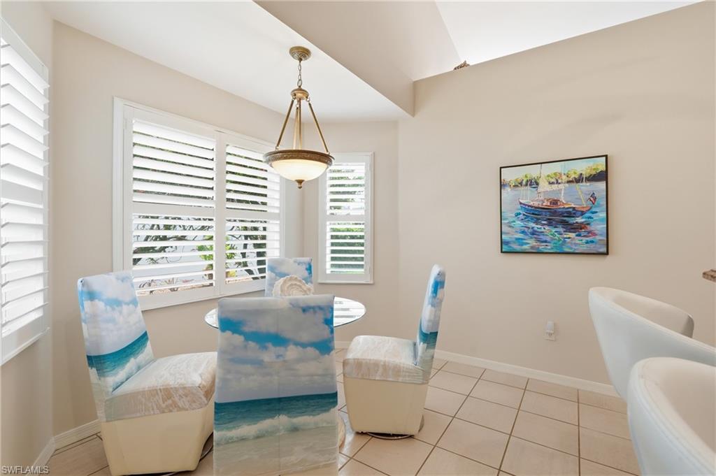 Dining area featuring multiple windows with louvered shutters