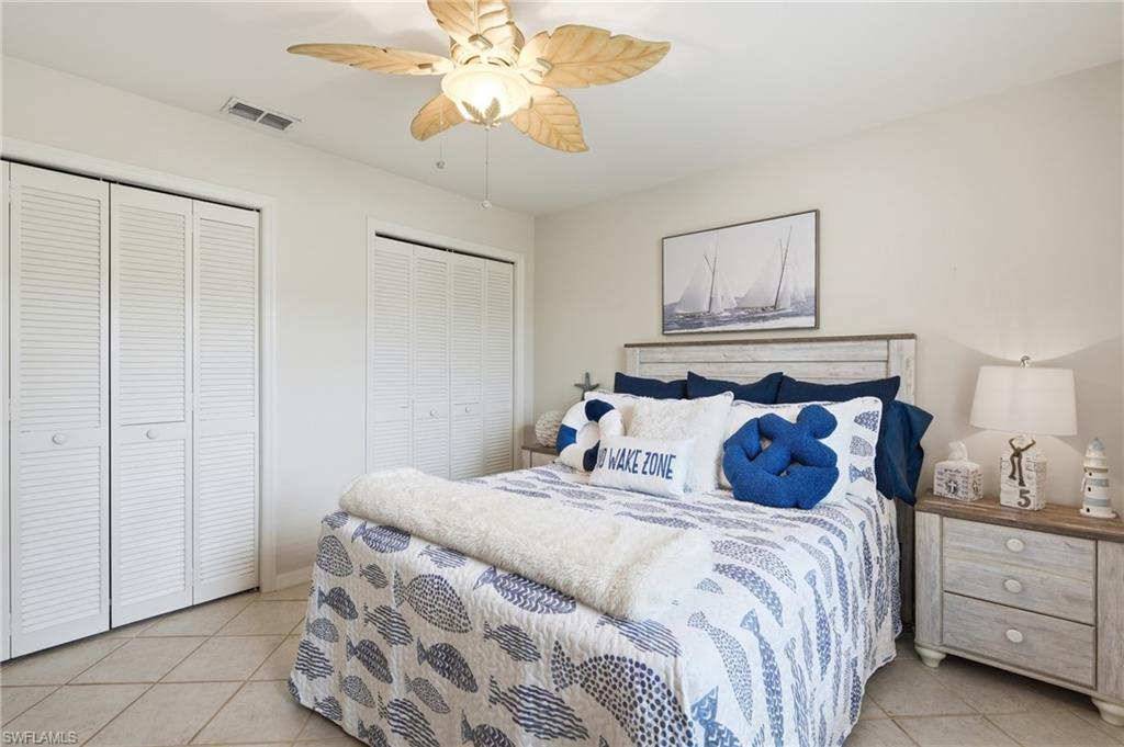 Neutral tone walls featuring a decorative ceiling fan with leaf-shaped blades