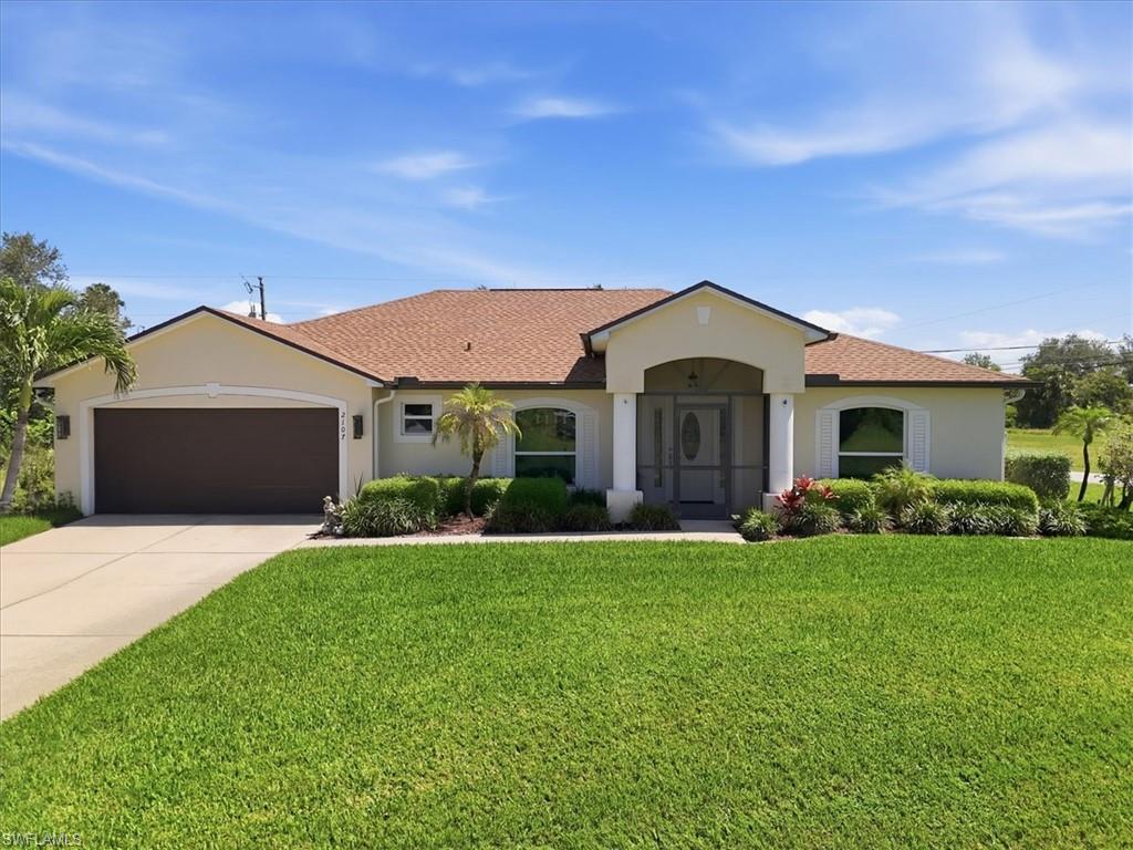 Single-story residence featuring a brown shingle roof and a beige exterior