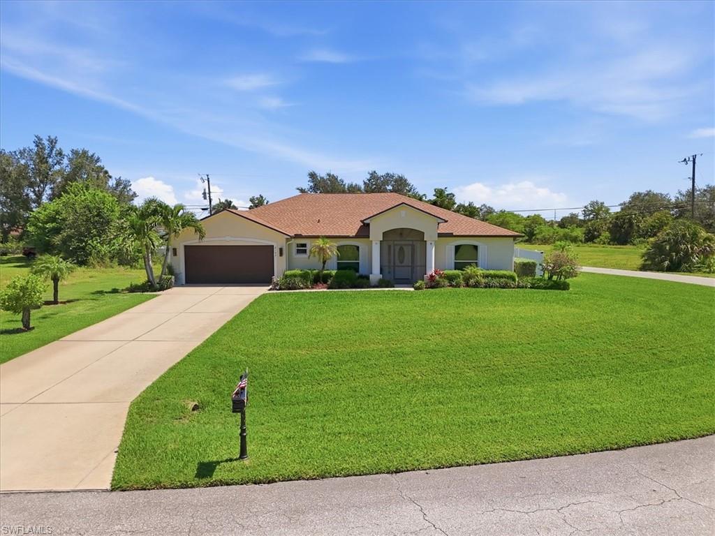 Ranch-style residence featuring a prominent brown garage door, concrete driveway, and a tan shingle roof