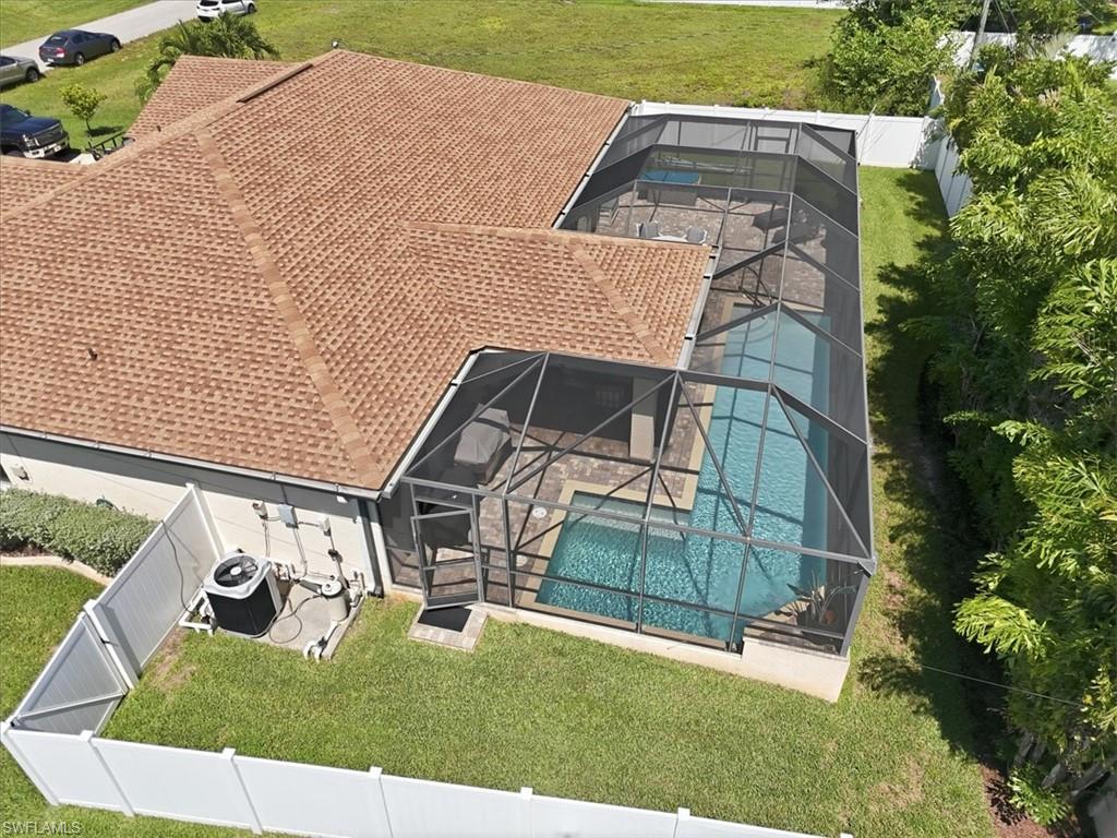 Screened lanai encompassing a swimming pool and hot tub