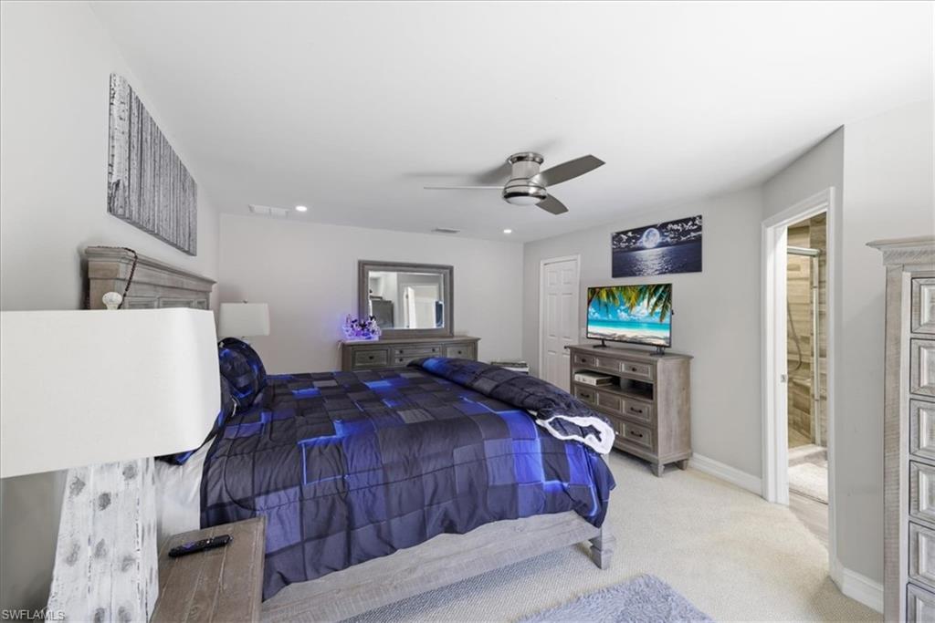 Spacious room featuring light-toned carpeting and neutral wall paint