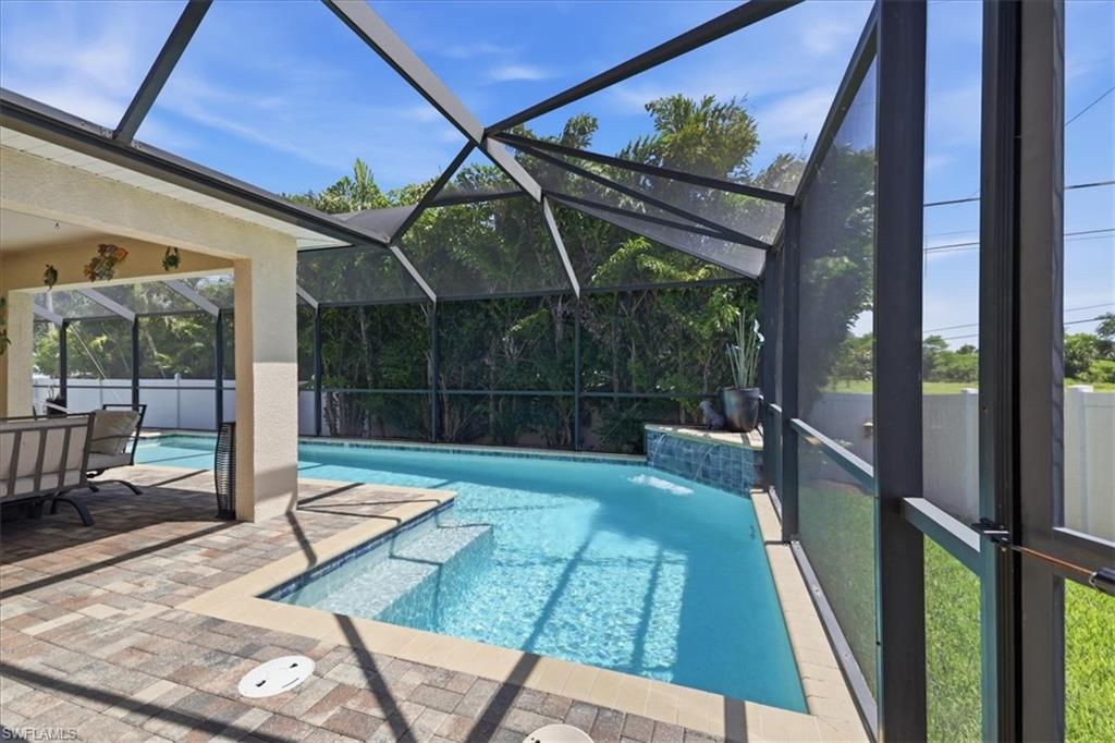 Screen-enclosed pool area featuring a paver patio and covered lanai