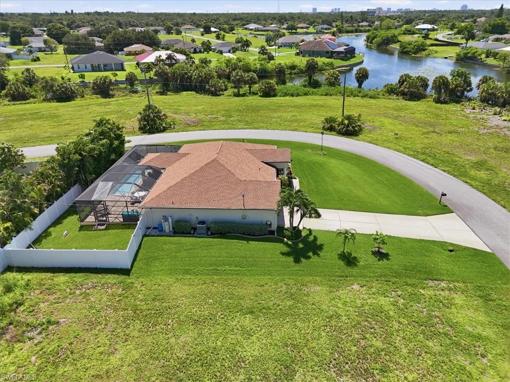 Single-story residence featuring a brown shingle roof and a screened-in pool enclosure
