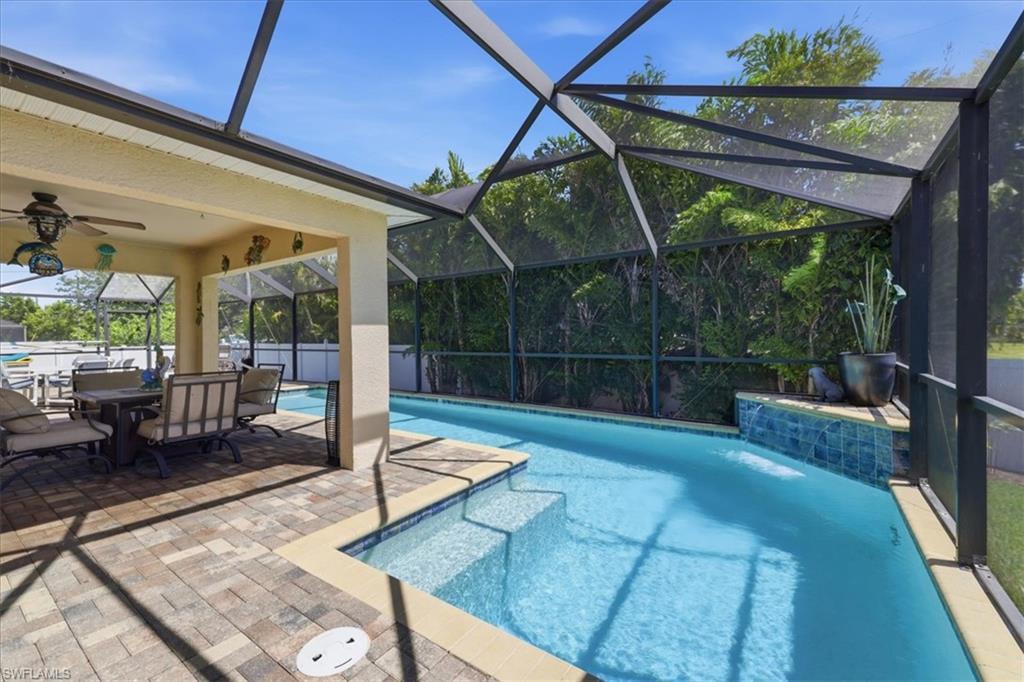 Screened pool area featuring a paver patio and covered lanai