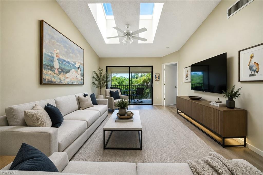 Vaulted ceiling with skylights and a ceiling fan