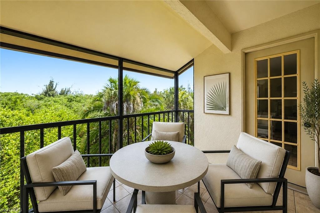 Screened balcony featuring a tiled floor and a private exterior