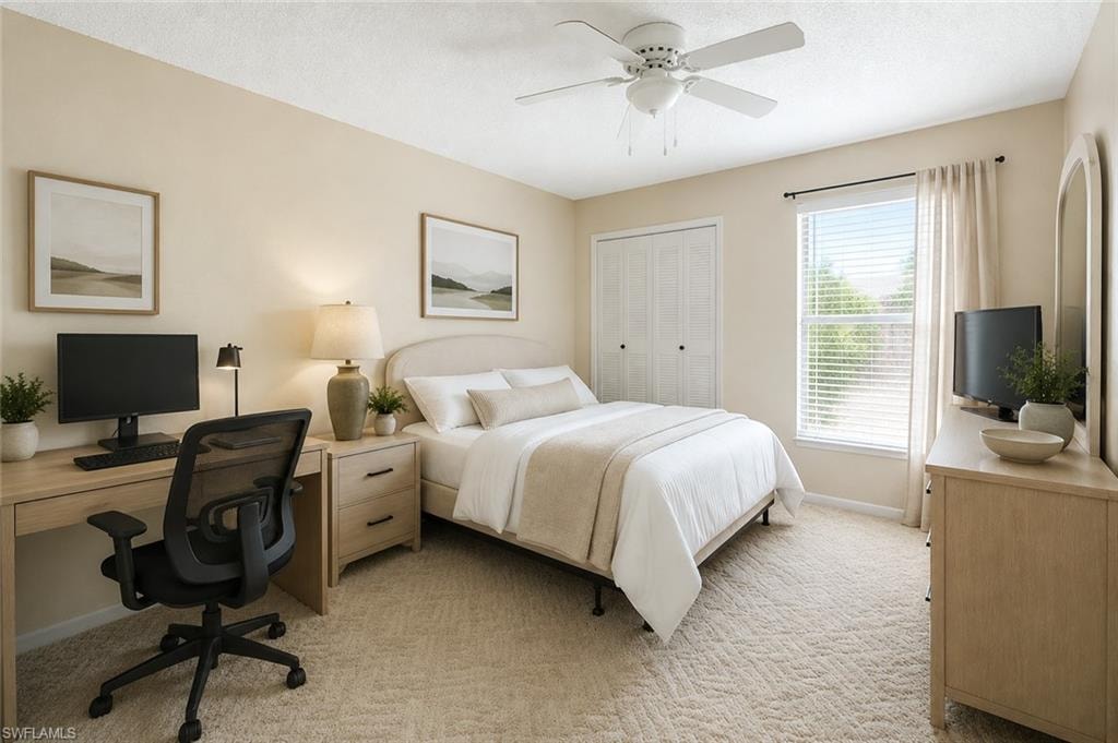 Carpeted bedroom featuring a ceiling fan, a window with blinds and drapes, and bi-fold closet doors
