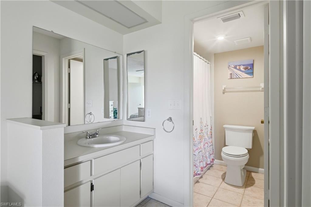 Bathroom featuring a white vanity with integrated sink, chrome faucet, and ample under-counter storage