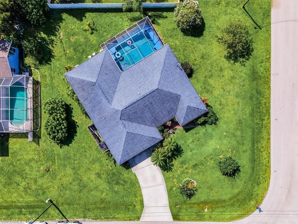 Aerial view showcasing a property with a screened-in swimming pool
