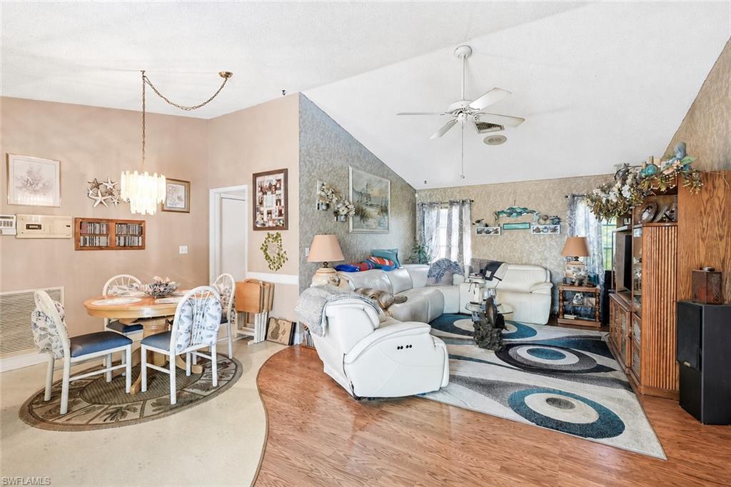 VIRTUALLY STAGED Vaulted ceiling with ceiling fan, wood-finish flooring, and built-in wood cabinetry