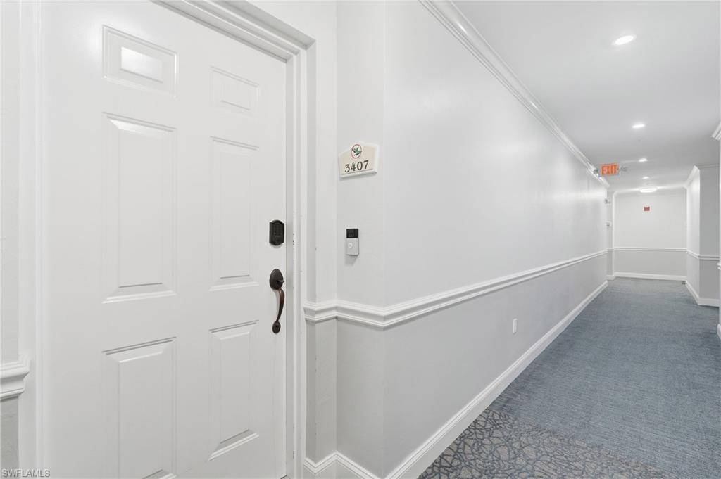 White paneled entry door with dark bronze hardware