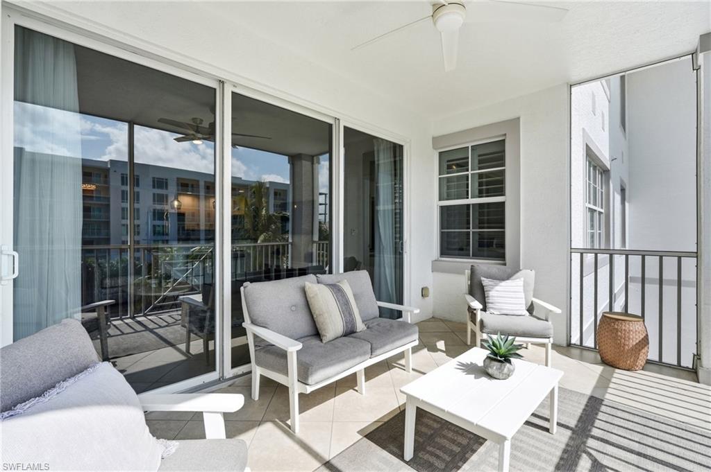 Screened-in balcony featuring tile flooring and a ceiling fan