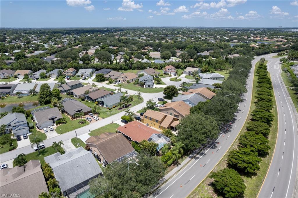 Aerial perspective showcasing a residential community with varied rooflines and extensive tree canopy