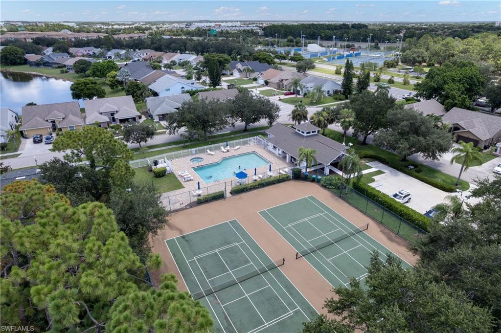 Community recreation area featuring two tennis courts, a swimming pool with a spa, and a clubhouse