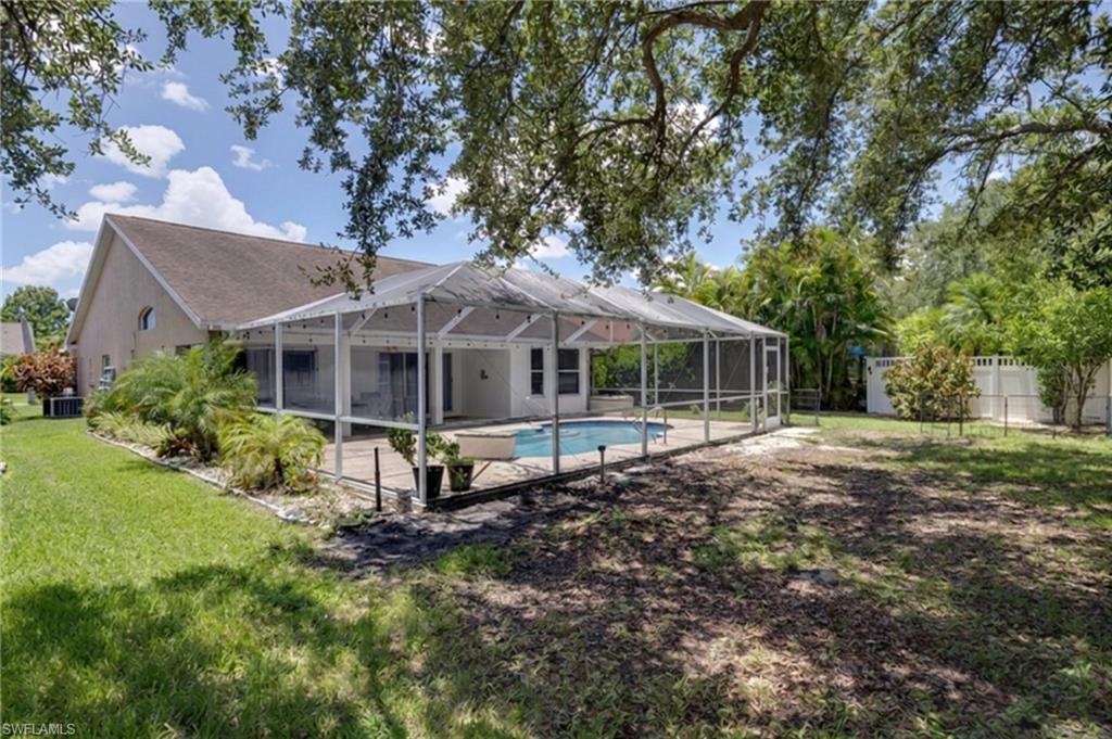 Expansive backyard featuring a screened-in pool and patio area