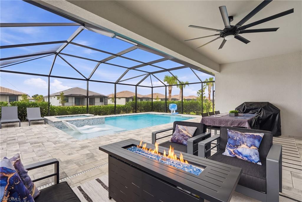 Screened lanai featuring a swimming pool, spa, and paver patio