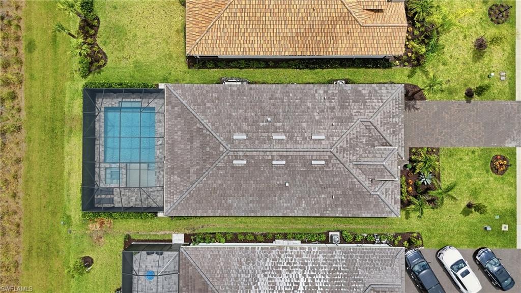 Overhead perspective showcasing a property with a screened swimming pool and spa