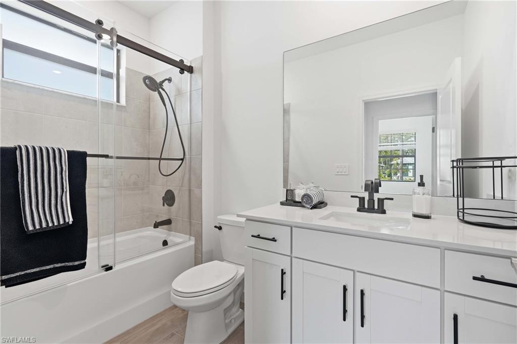 Contemporary bathroom featuring a white vanity with shaker-style cabinetry, a rectangular undermount sink, and a quartz countertop