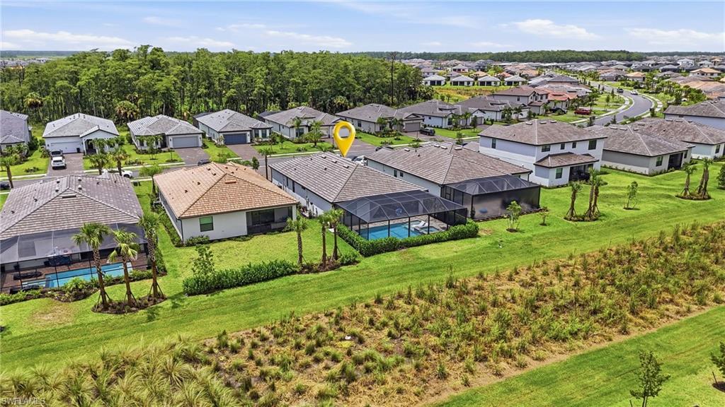 Aerial overview of a residential community featuring single-story homes with shingle roofs