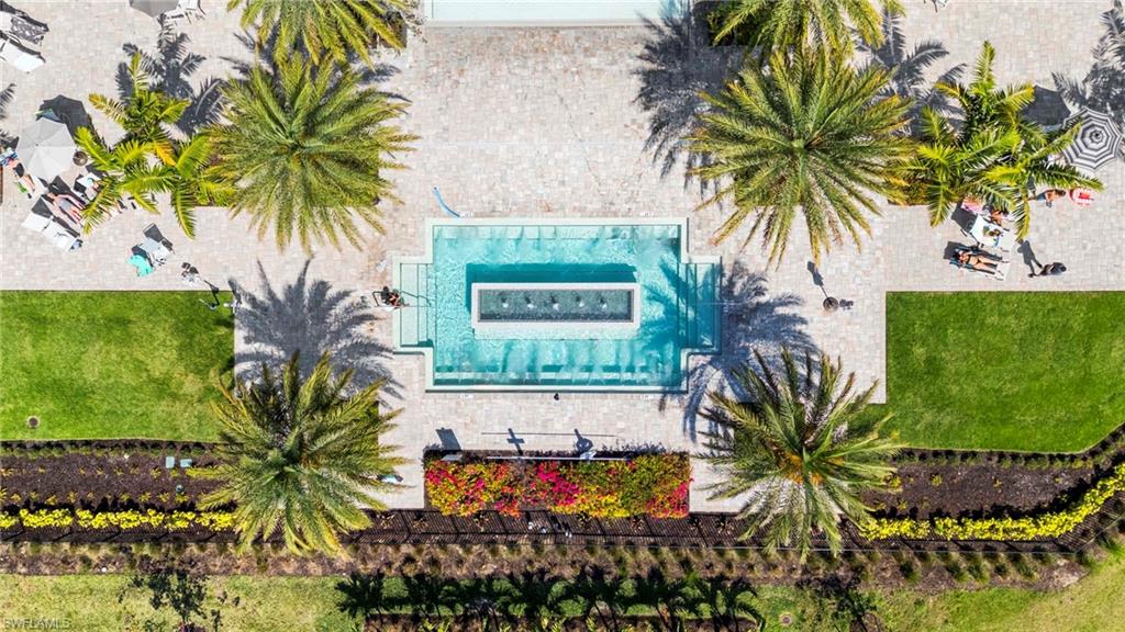 Central swimming pool with a rectangular water feature, surrounded by extensive paver decking