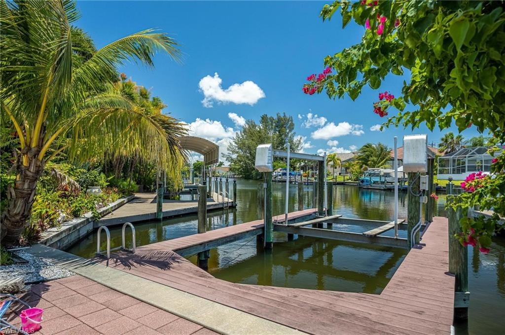 Dock area with boat lift and a water view