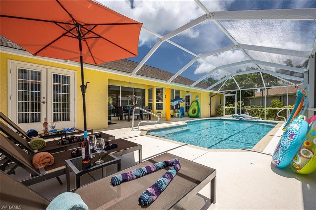 Outdoor pool with a patio, an outdoor living space, french doors, and glass enclosure