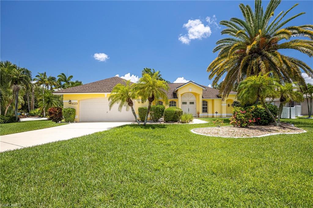View of front of property with concrete driveway, a garage, stucco siding, and a front lawn