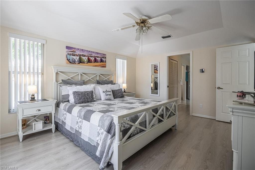 Bedroom featuring light wood-style flooring, baseboards, and ceiling fan