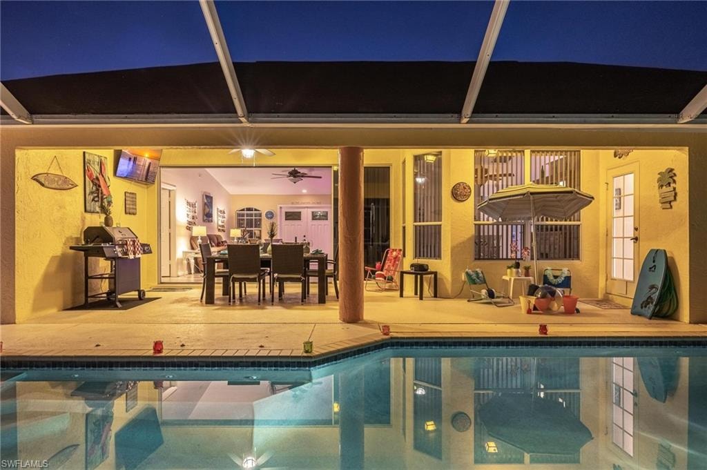 Outdoor pool with a patio area and a ceiling fan