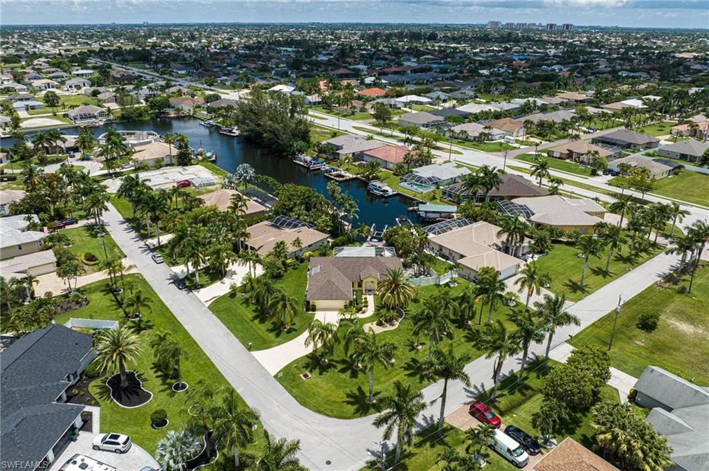 Aerial view of property's location featuring nearby suburban area and a large body of water
