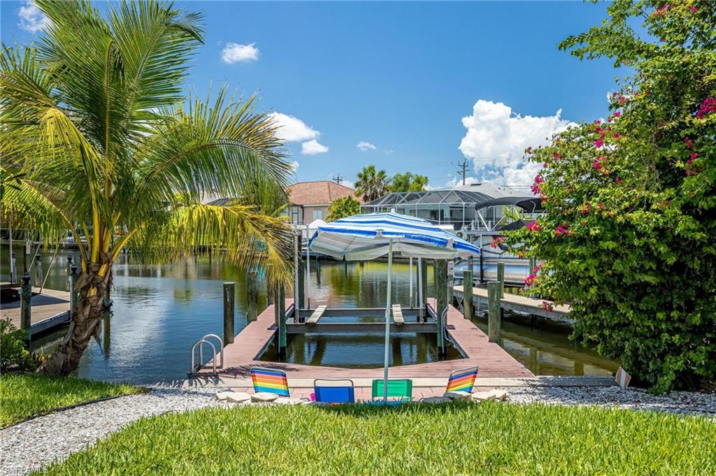 Dock area featuring boat lift and a water view