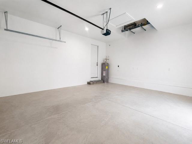 Garage Angle 2- Clean, spacious garage with room for vehicles, tools, and recreational equipment.