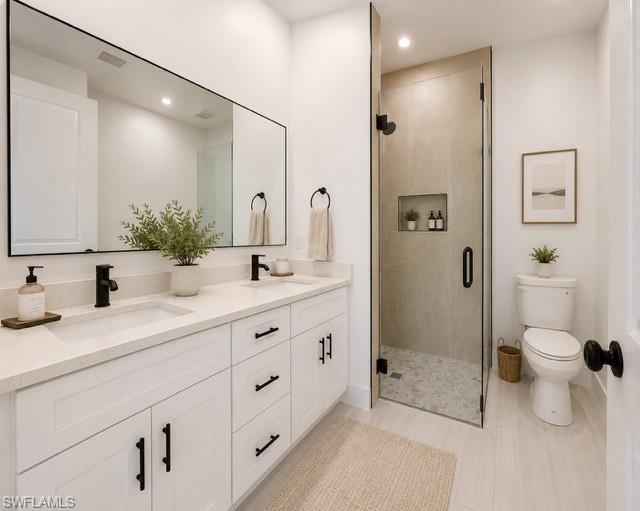 Well-appointed primary bath featuring dual vanities and a walk-in shower.