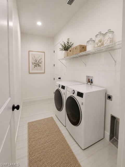 Dedicated indoor laundry room with additional storage space.