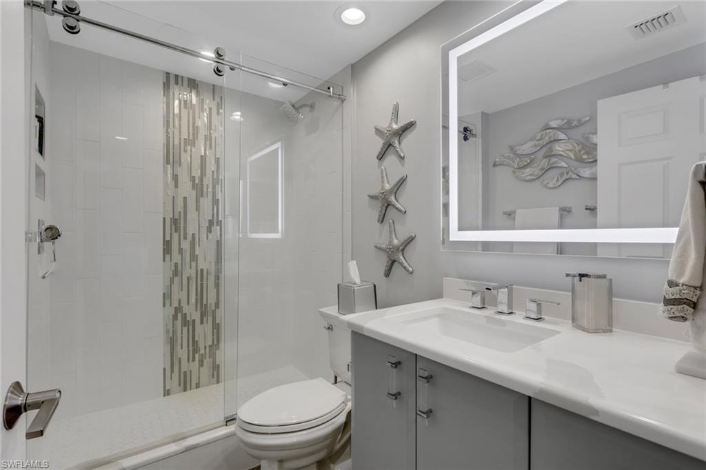 Full bath featuring vanity and a stall shower