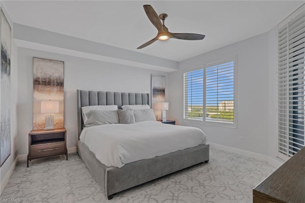 Bedroom with a ceiling fan and baseboards