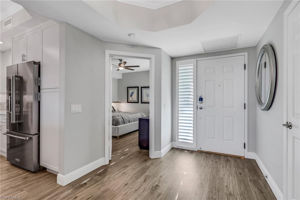 Entrance foyer with light wood finished floors and ceiling fan