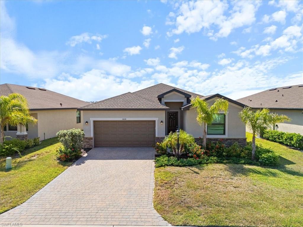 Contemporary stucco exterior featuring a stone accent façade, an arched entry, a two-car garage, and a paver driveway