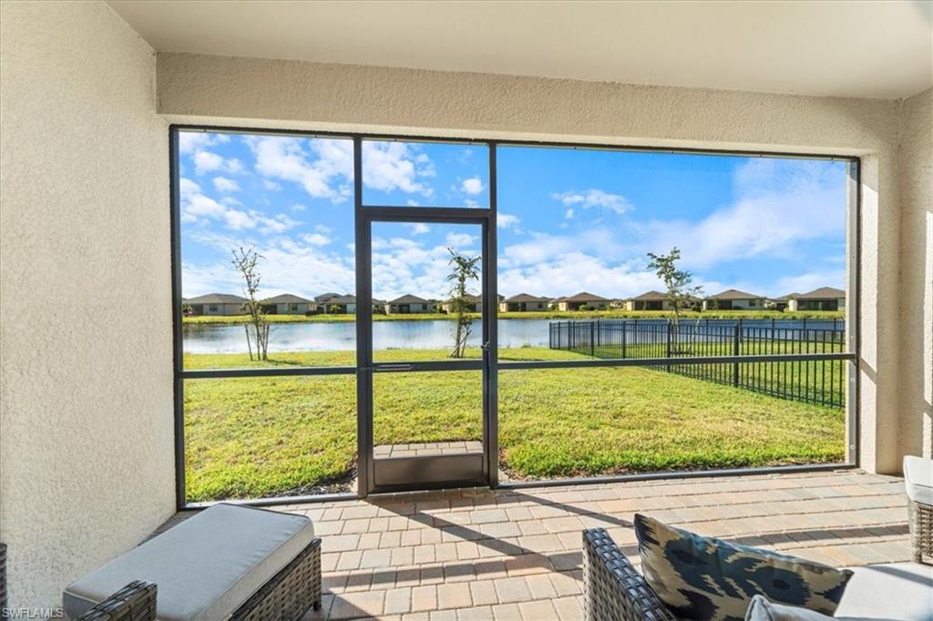 Screened lanai featuring paver flooring and textured stucco walls