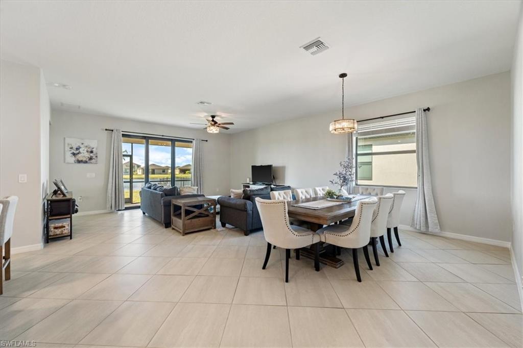 Open-concept living and dining area featuring large format tile flooring throughout