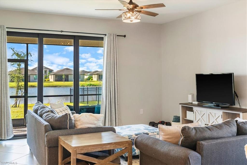 Sliding glass doors opening to a screened lanai overlooking a body of water