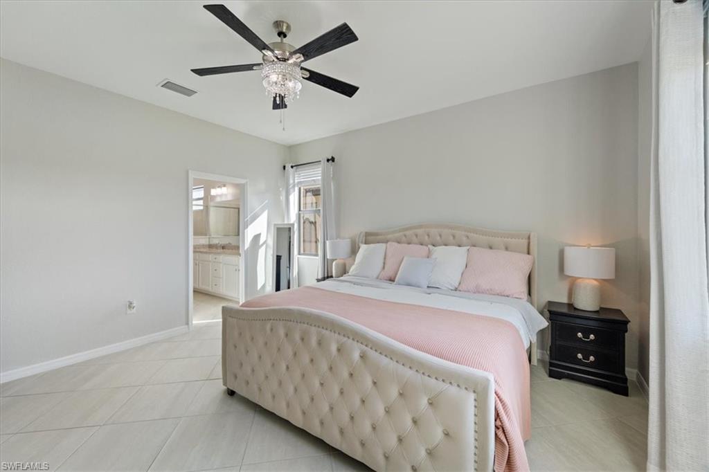 Spacious bedroom with light-toned tile flooring and neutral wall paint