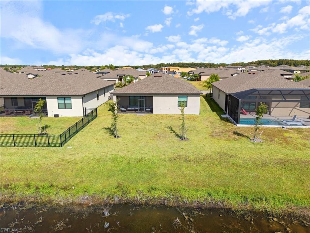 Rear property exterior featuring a screened patio and private yard space