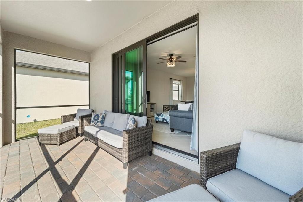 Covered patio featuring a paver floor and screened enclosure